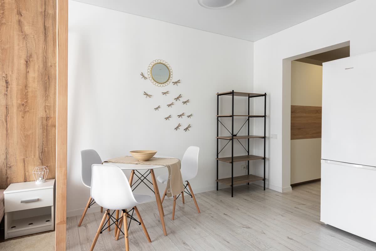 A small dining table with chairs in a bright apartment