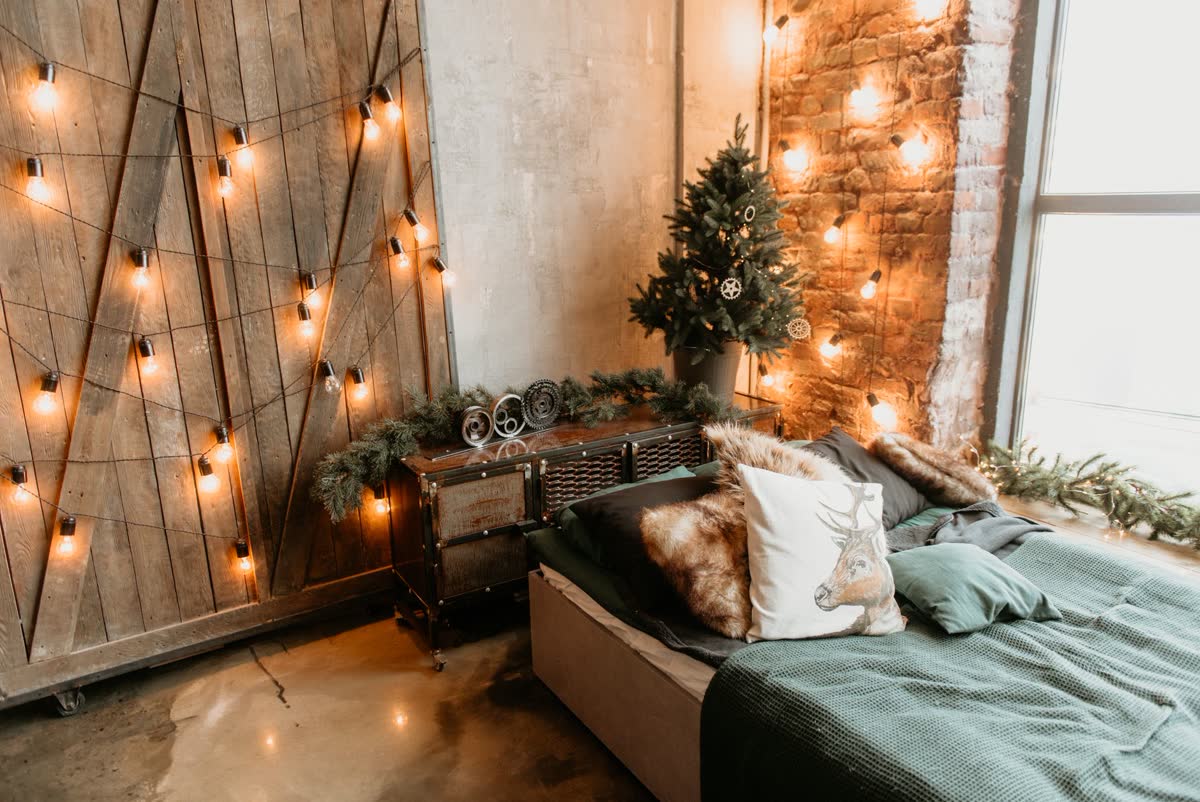 Warm string lights over a cozy bed