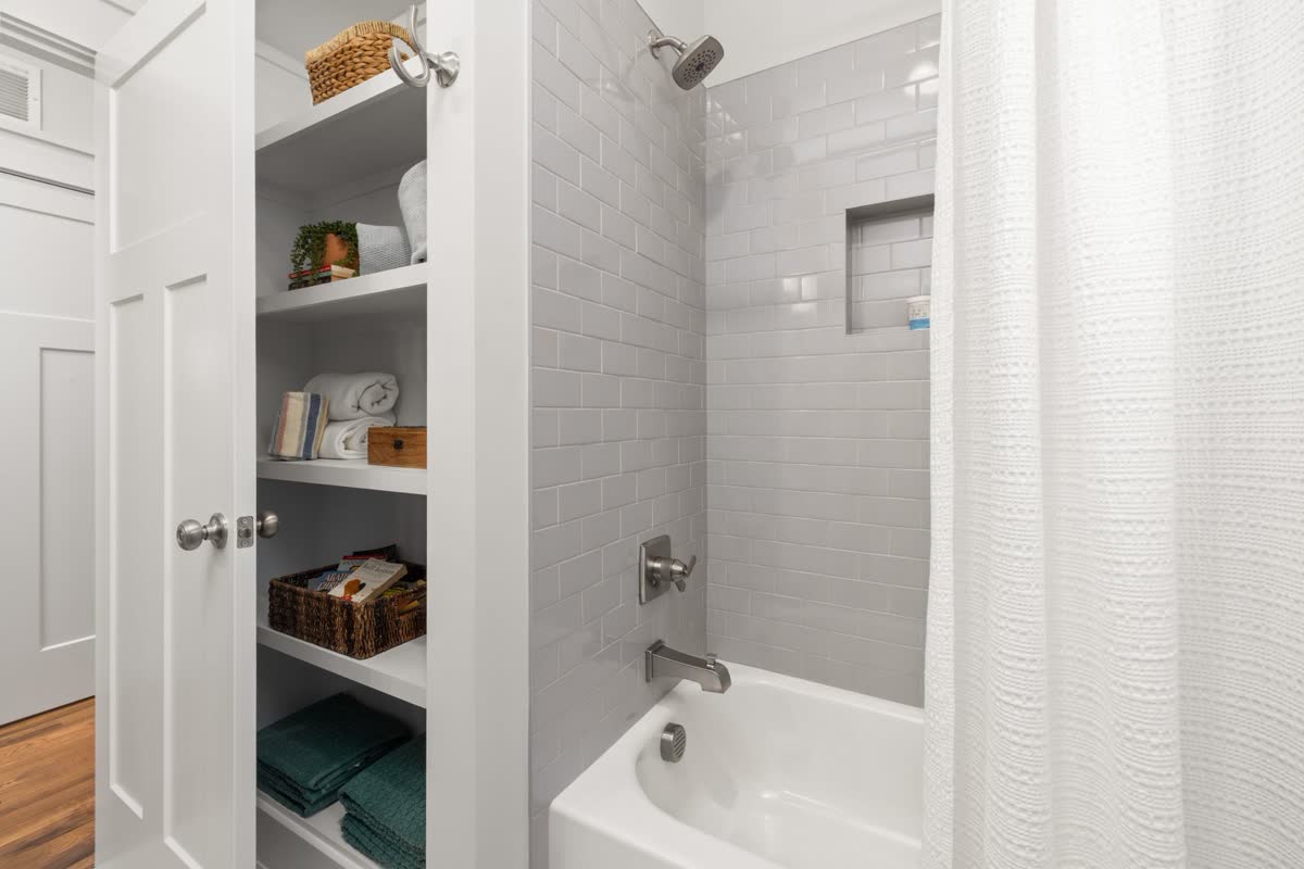 Toiletries neatly arranged on a shower shelf
