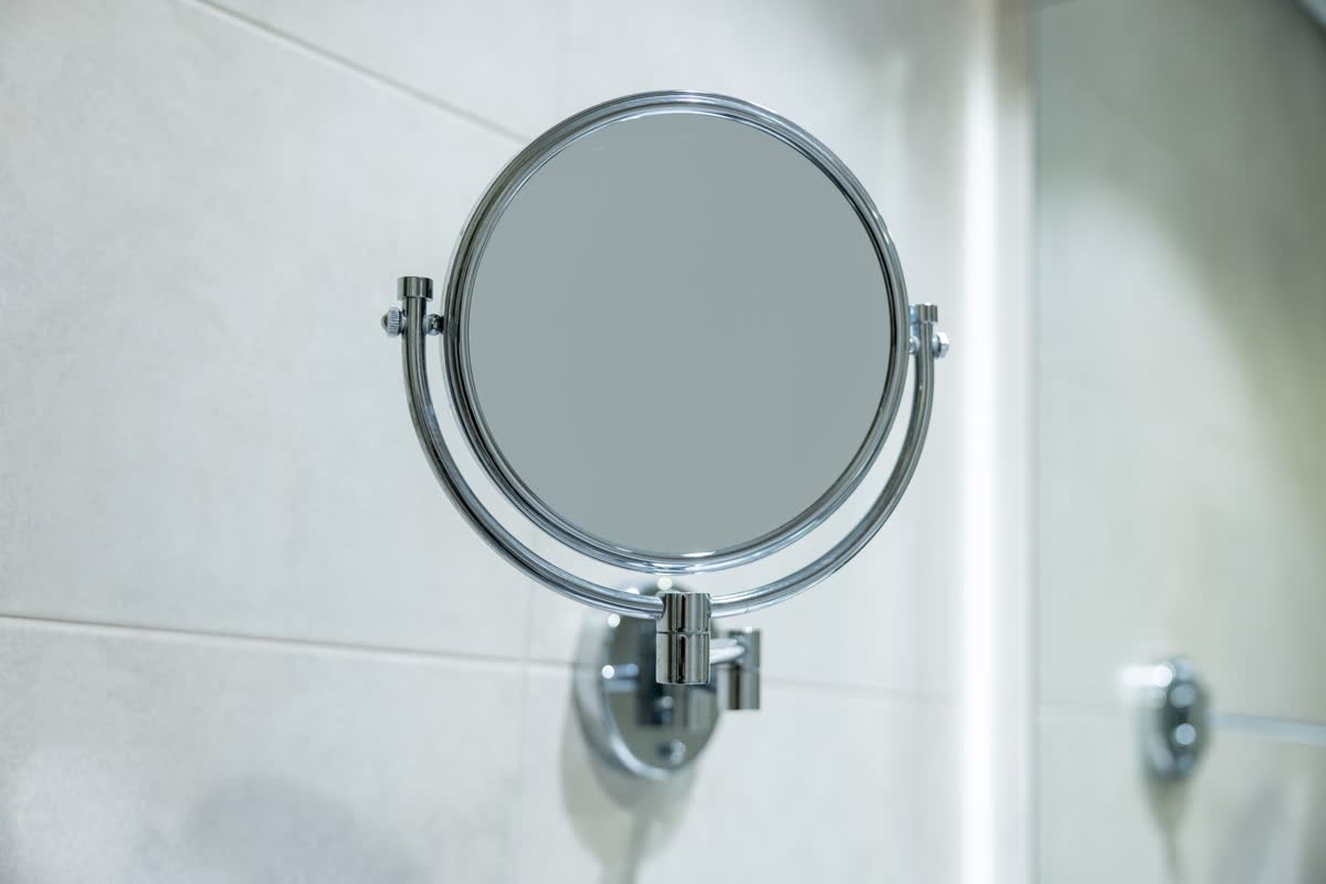 A small round mirror on a wall