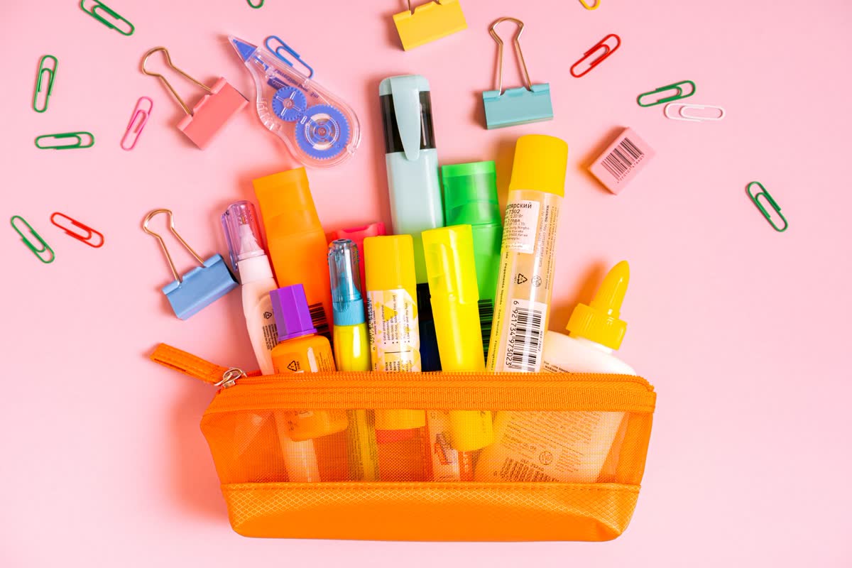 A caddy full of pens and school supplies