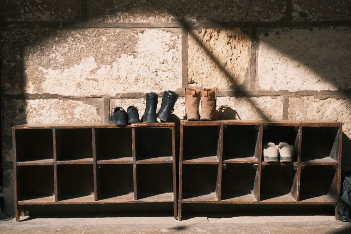 A shoe rack with shoes and boots