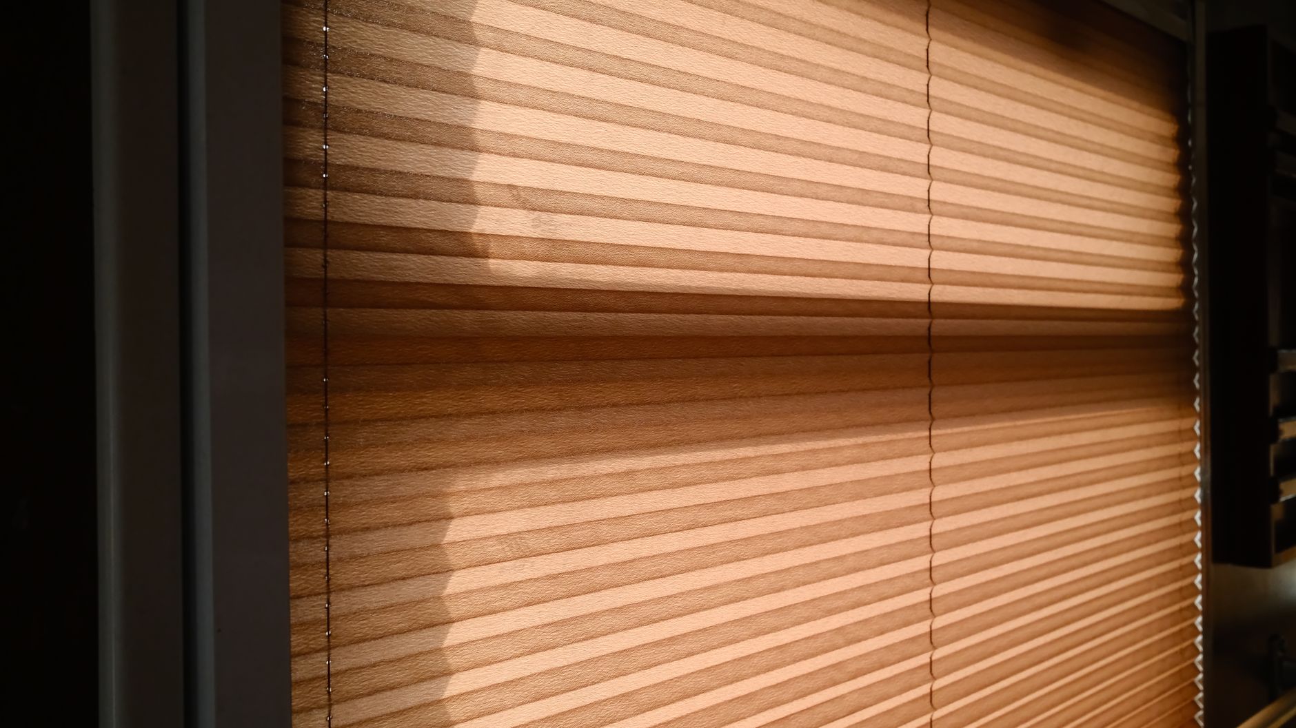 Closed blinds keeping a room cool during a heat wave