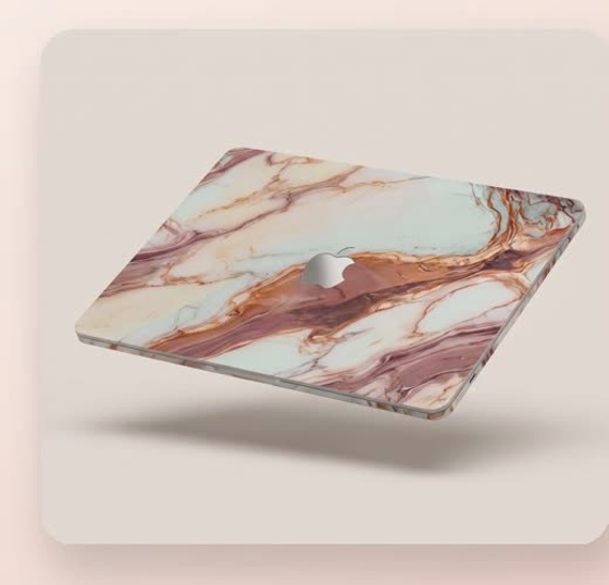 A WRAPT rose quartz vinyl skin on a MacBook