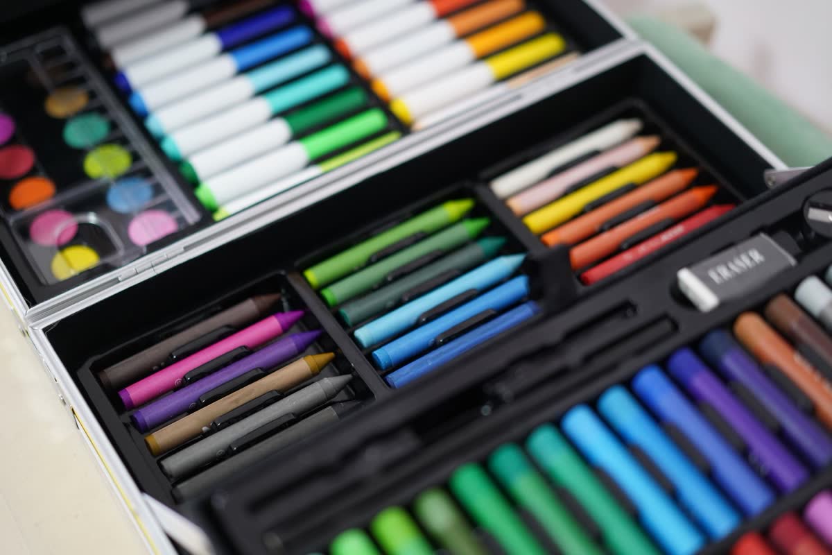 An open case of colorful art markers and supplies
